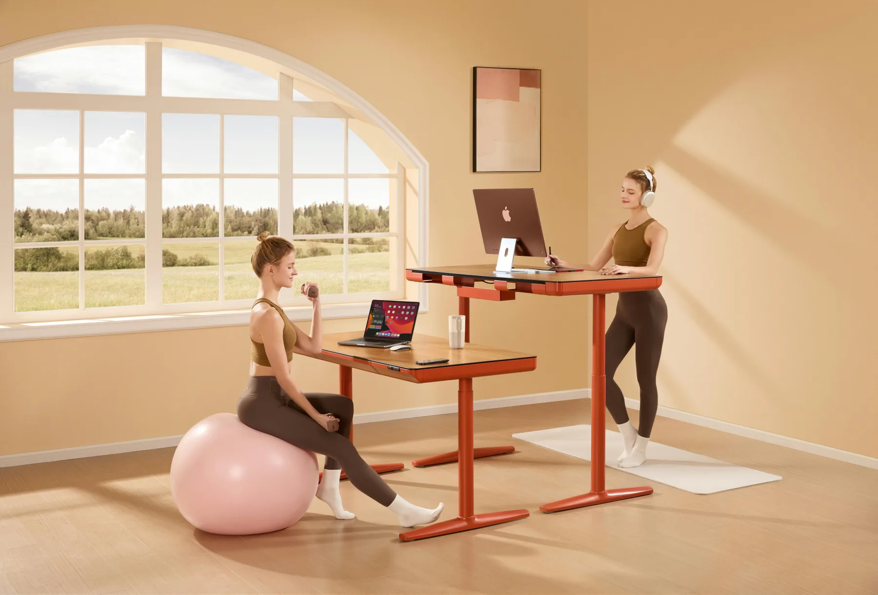 Two adults beside desks in a bright exercise-friendly workspace