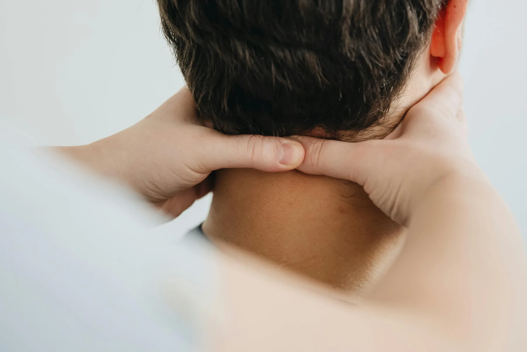 An adult holding the back of the neck